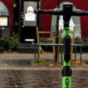 Elsparkcykel ligger vält på en cykelbana en mörk kväll